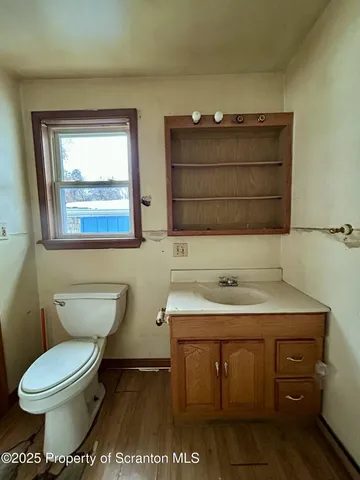 a bathroom with a sink toilet and mirror