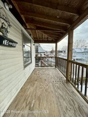 a view of porch with wooden floor