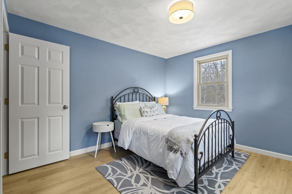 4 Apple Ridge Road, Unit 6 Maynard, MA 01754 - Photo 18 of 40 a bedroom with a bed and a window