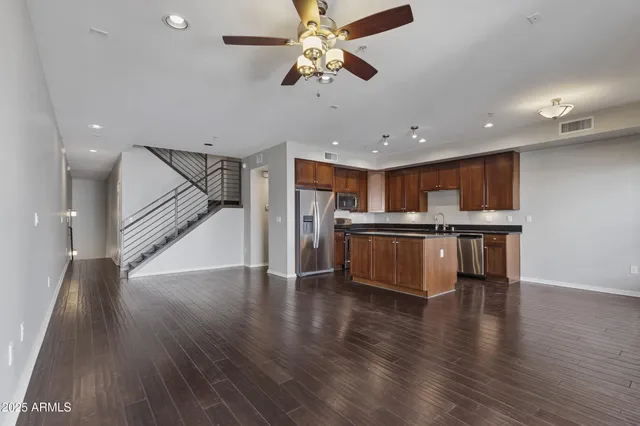 a kitchen with stainless steel appliances a refrigerator and a stove top oven