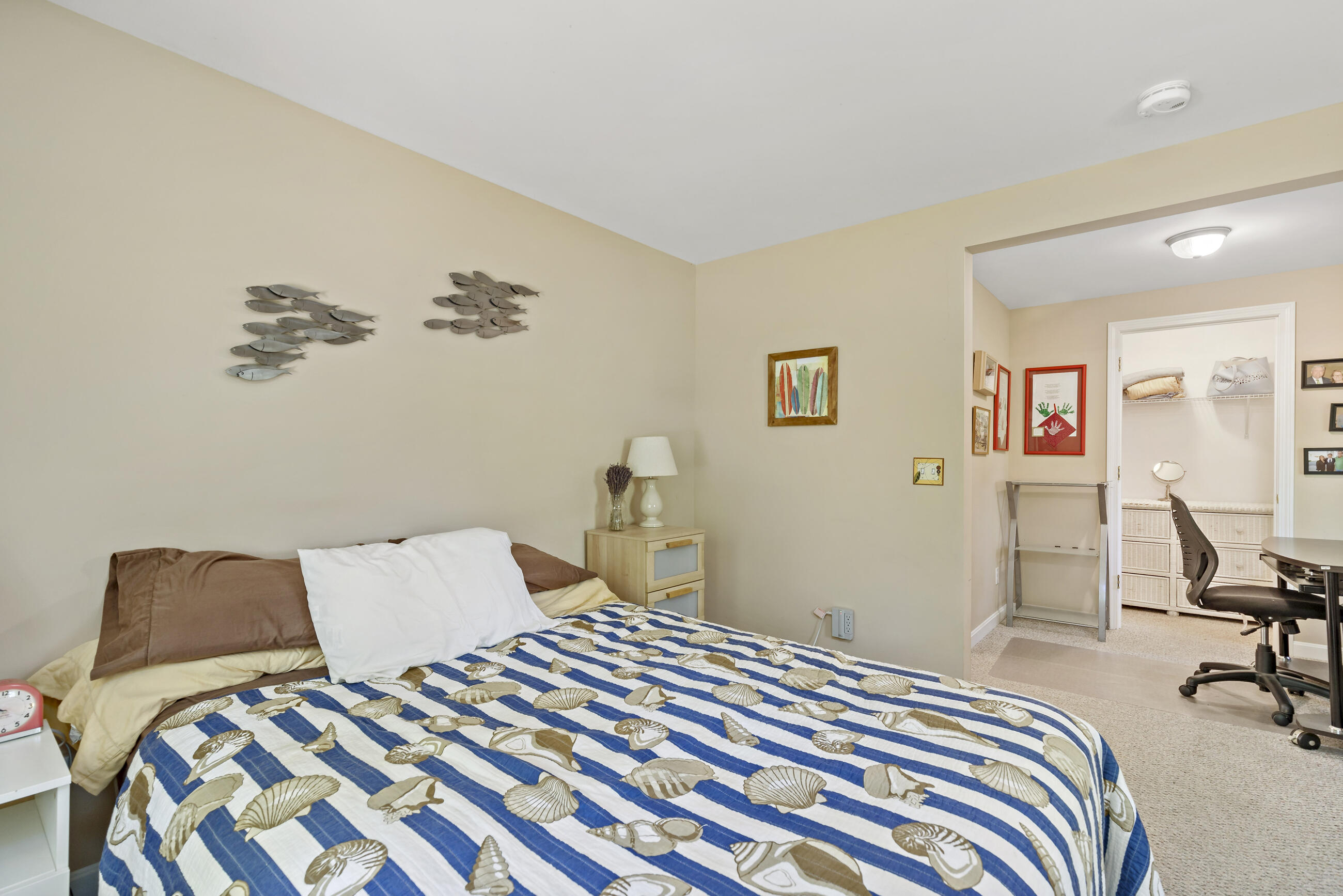 35 Whitney Road Eastham, MA 02642 - Photo 15 of 31 a bedroom with a bed and a chair