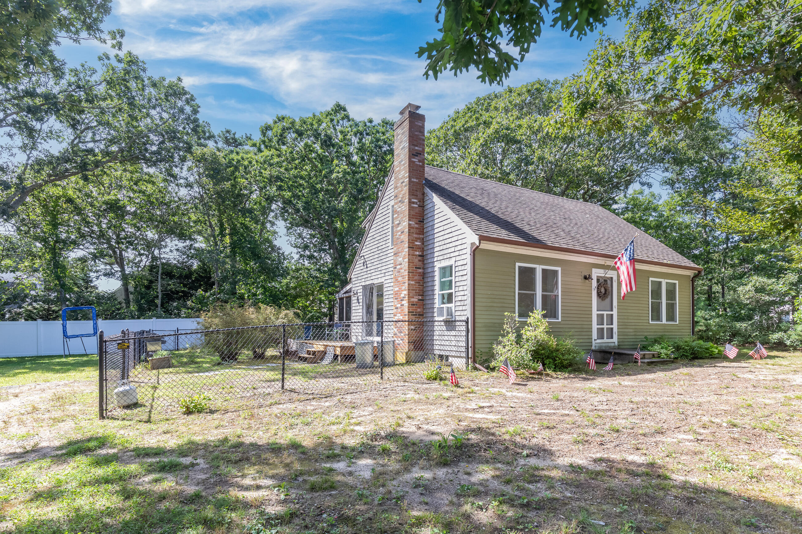 35 Whitney Road Eastham, MA 02642 - Photo 2 of 31 a view of a house with backyard and sitting area