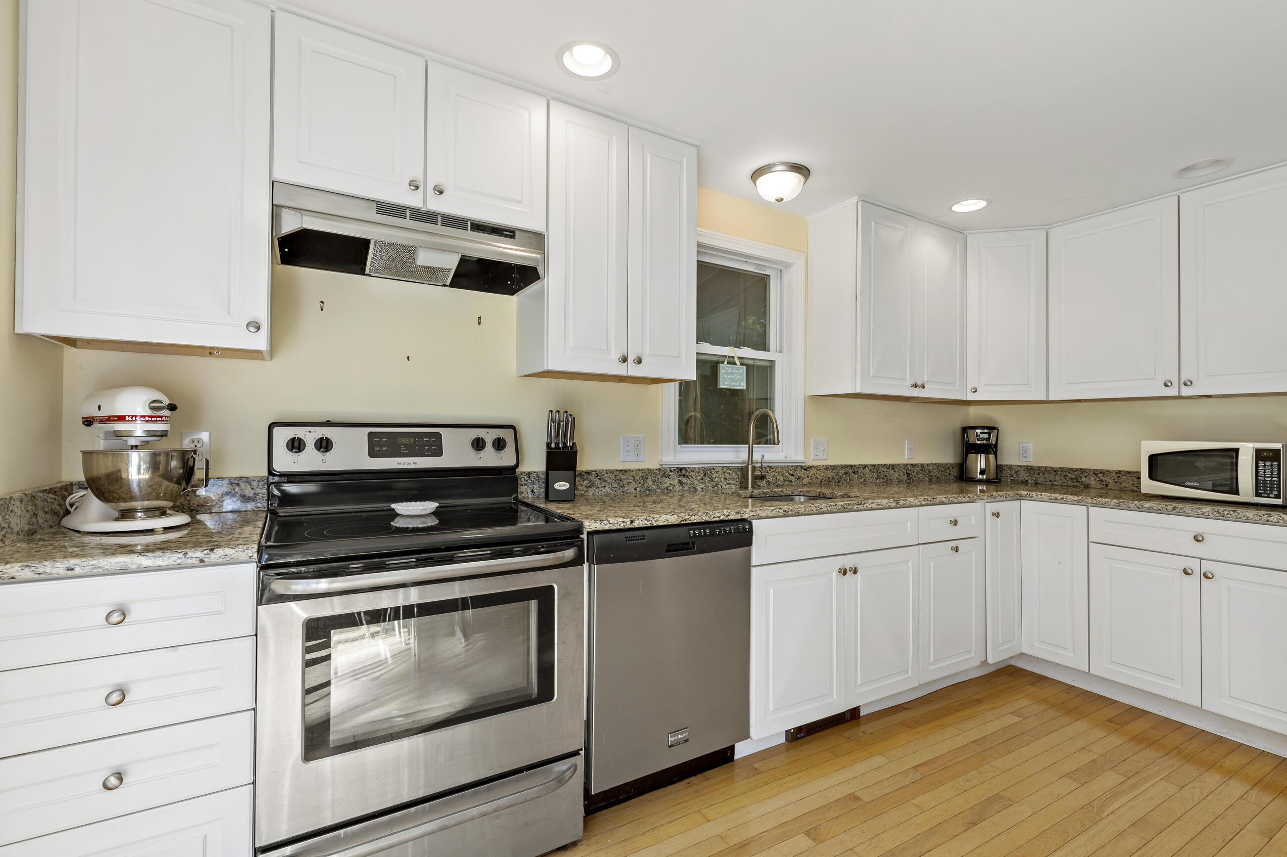 35 Whitney Road Eastham, MA 02642 - Photo 6 of 31 a kitchen with stainless steel appliances granite countertop a stove and white cabinets