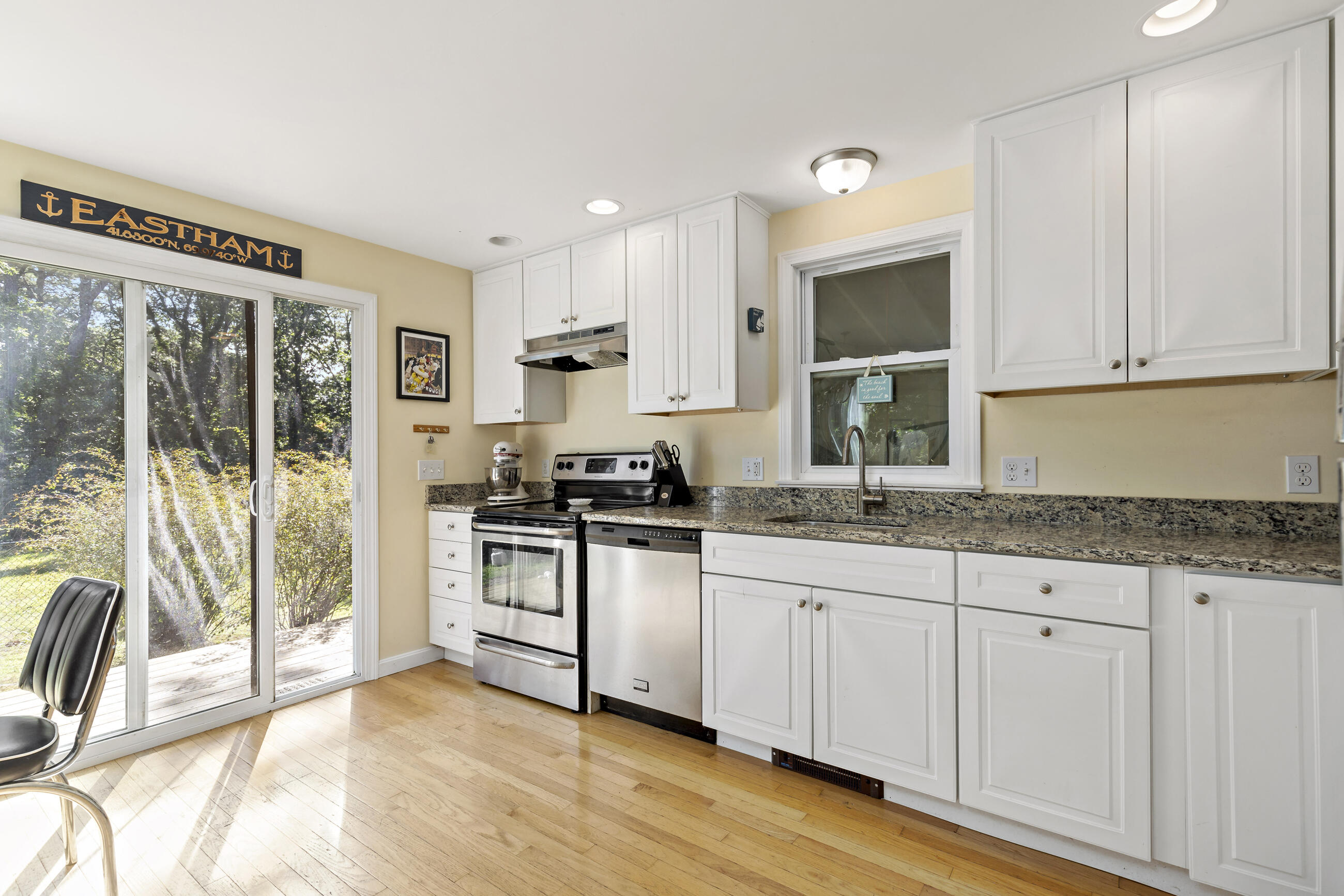 35 Whitney Road Eastham, MA 02642 - Photo 8 of 31 a kitchen with granite countertop a sink and white cabinets