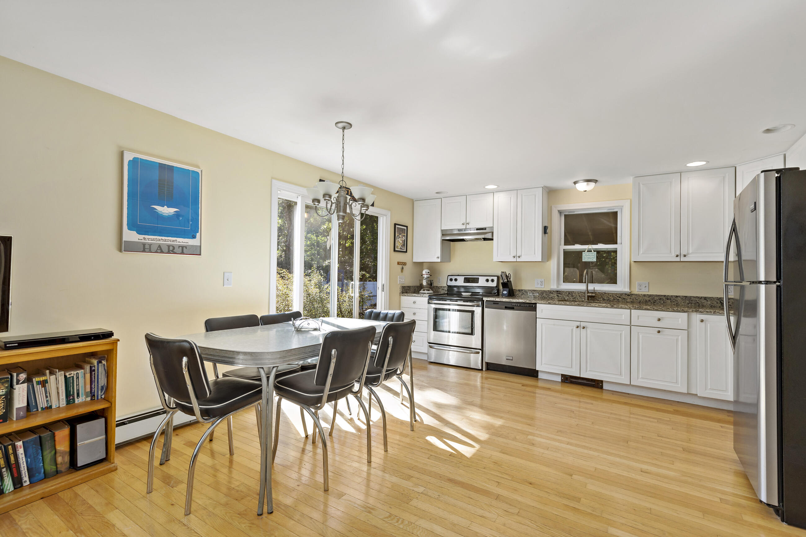 35 Whitney Road Eastham, MA 02642 - Photo 10 of 31 a kitchen with stainless steel appliances wooden floor and a refrigerator