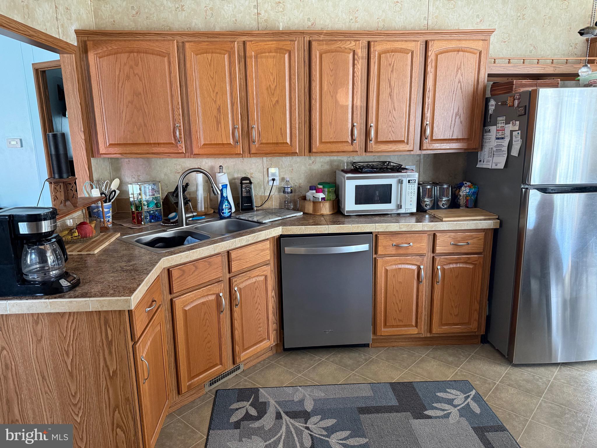 821 Rum Bridge Branch Road Seaford, DE 19973 - Photo 6 of 15 a kitchen with stainless steel appliances granite countertop a refrigerator a sink a stove a washer and dryer
