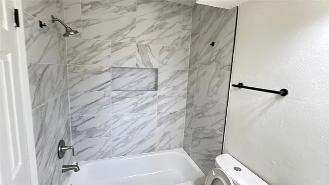 a bathroom with a bathtub and shower