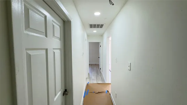 a view of a hallway with wooden shelves