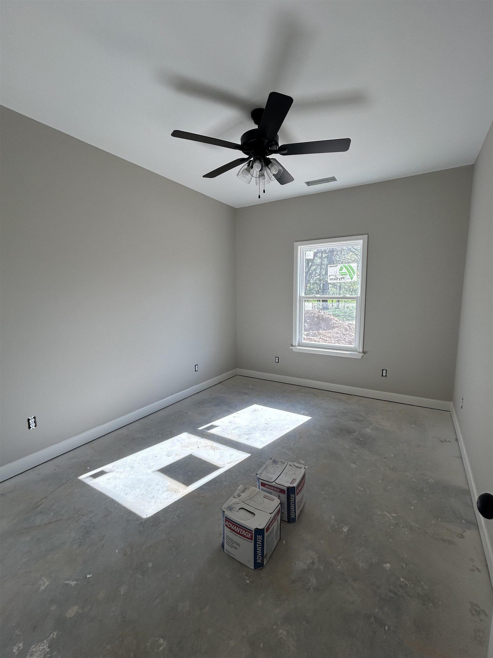 1805 Wortham Road Atoka, TN 38004 - Photo 9 of 20 Spare room with concrete floors, visible vents, baseboards, and a ceiling fan