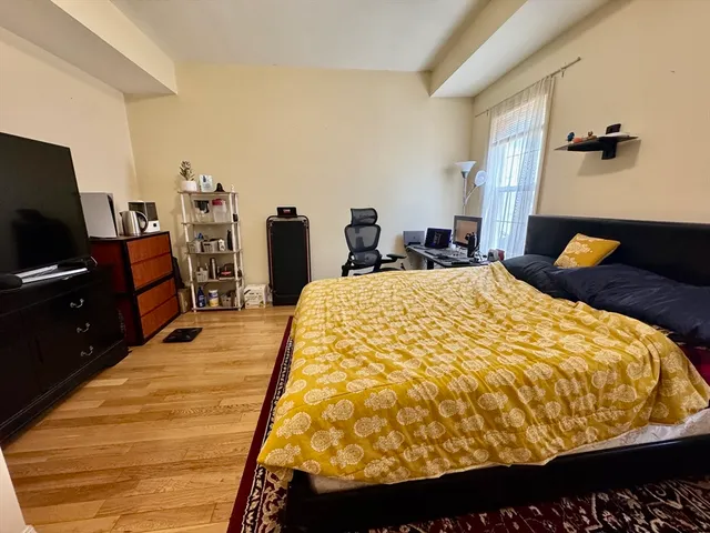 a bed sitting in a bedroom next to a window