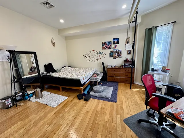 a bathroom with a granite countertop bathtub sink vanity mirror and toilet