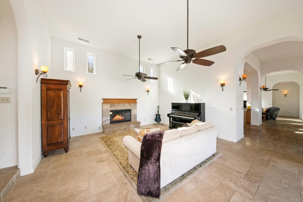 15460 Markar Road Poway, CA 92064 - Photo 12 of 36 a living room with furniture a fireplace and a chandelier