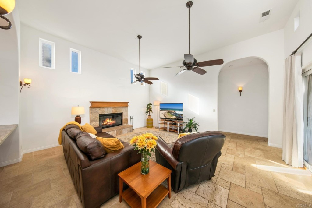 15460 Markar Road Poway, CA 92064 - Photo 14 of 36 a living room with furniture a fireplace and a chandelier