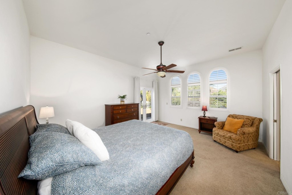 15460 Markar Road Poway, CA 92064 - Photo 17 of 36 a spacious bedroom with a bed and a couch