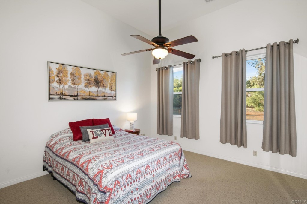15460 Markar Road Poway, CA 92064 - Photo 21 of 36 a bedroom with a bed and wooden floor