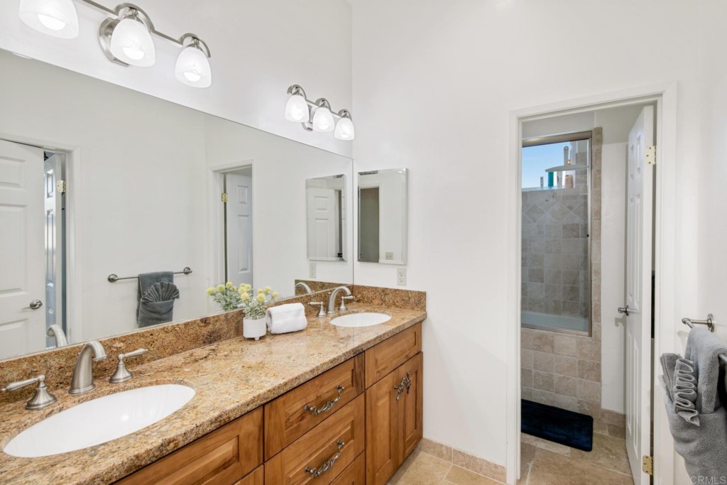 15460 Markar Road Poway, CA 92064 - Photo 23 of 36 a bathroom with a granite countertop double vanity sink and mirror