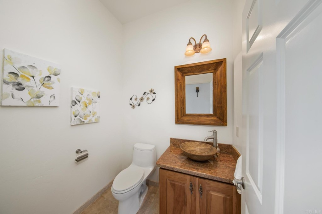15460 Markar Road Poway, CA 92064 - Photo 24 of 36 a bathroom with a sink mirror vanity and toilet