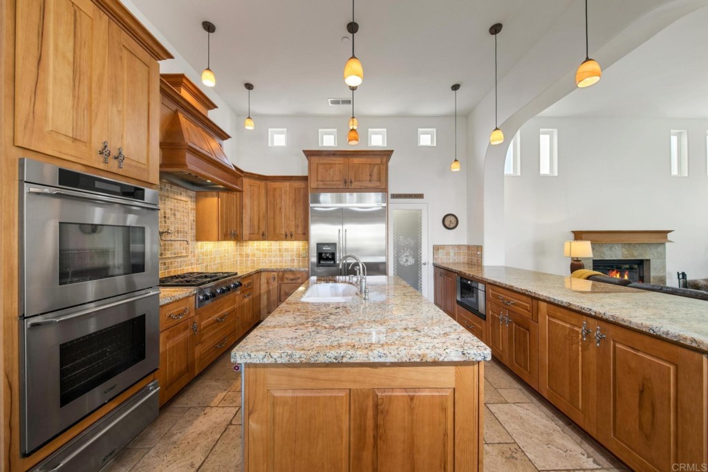 15460 Markar Road Poway, CA 92064 - Photo 9 of 36 a kitchen with granite countertop kitchen island stainless steel appliances a stove sink and microwave