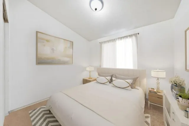 a bedroom with a bed and window