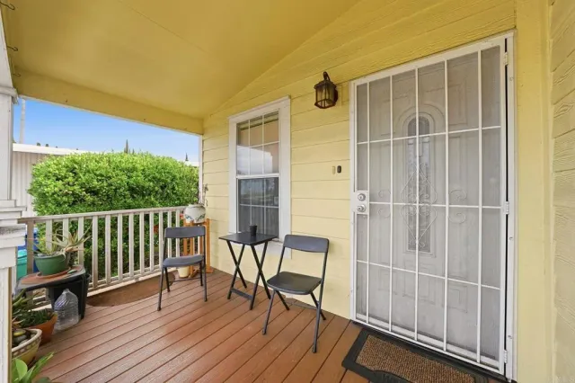 a view of a balcony with chair and wooden floor