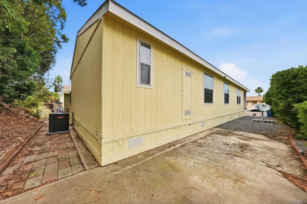 10767 Jamacha Spring Valley, Unit SPC 119 Spring Valley, CA 91978 - Photo 19 of 25 a view of a house with backyard and trees