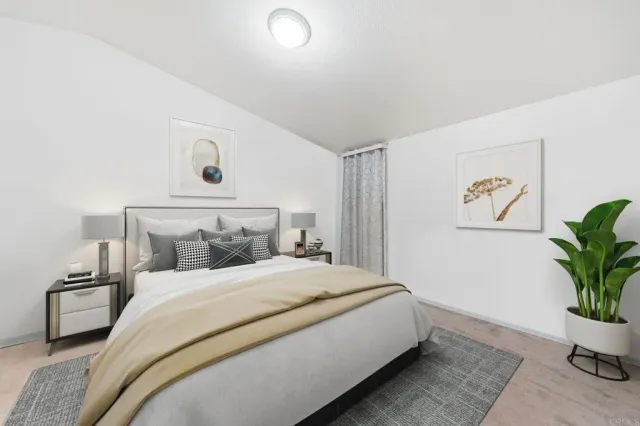 a bedroom with a bed and a potted plant