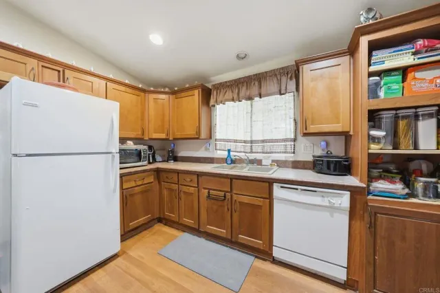 a kitchen with a refrigerator a sink and cabinets
