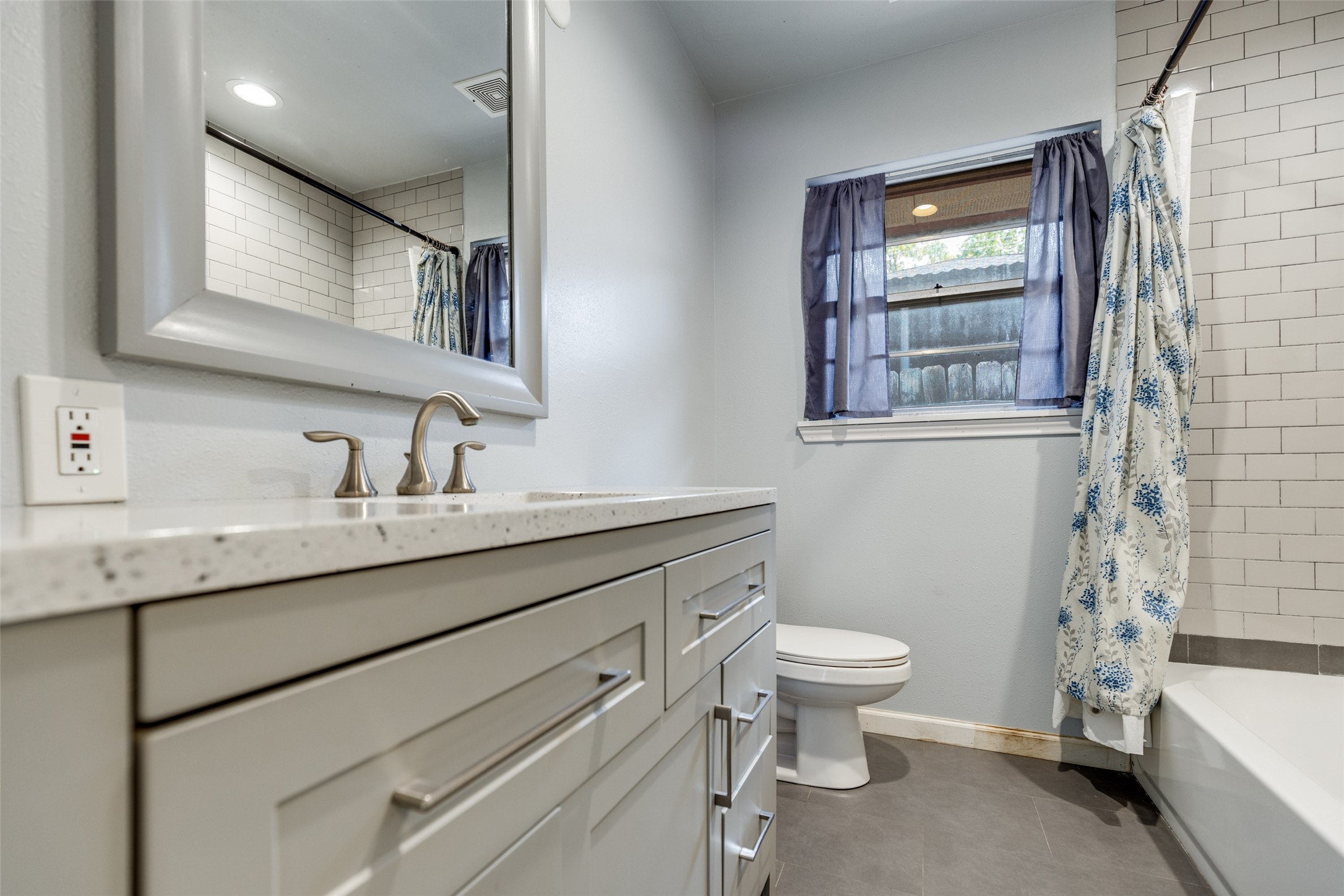 2007 Hewitt Drive Houston, TX 77018 - Photo 18 of 25 a bathroom with a granite countertop sink a toilet and a mirror