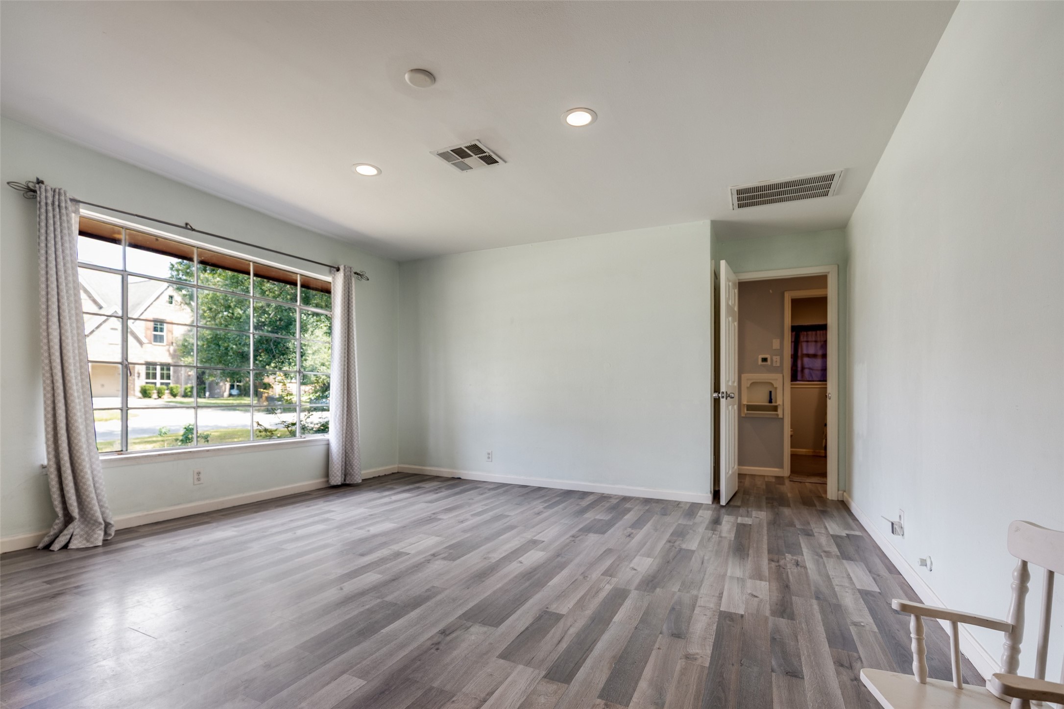2007 Hewitt Drive Houston, TX 77018 - Photo 3 of 25 wooden floor in an empty room with a window