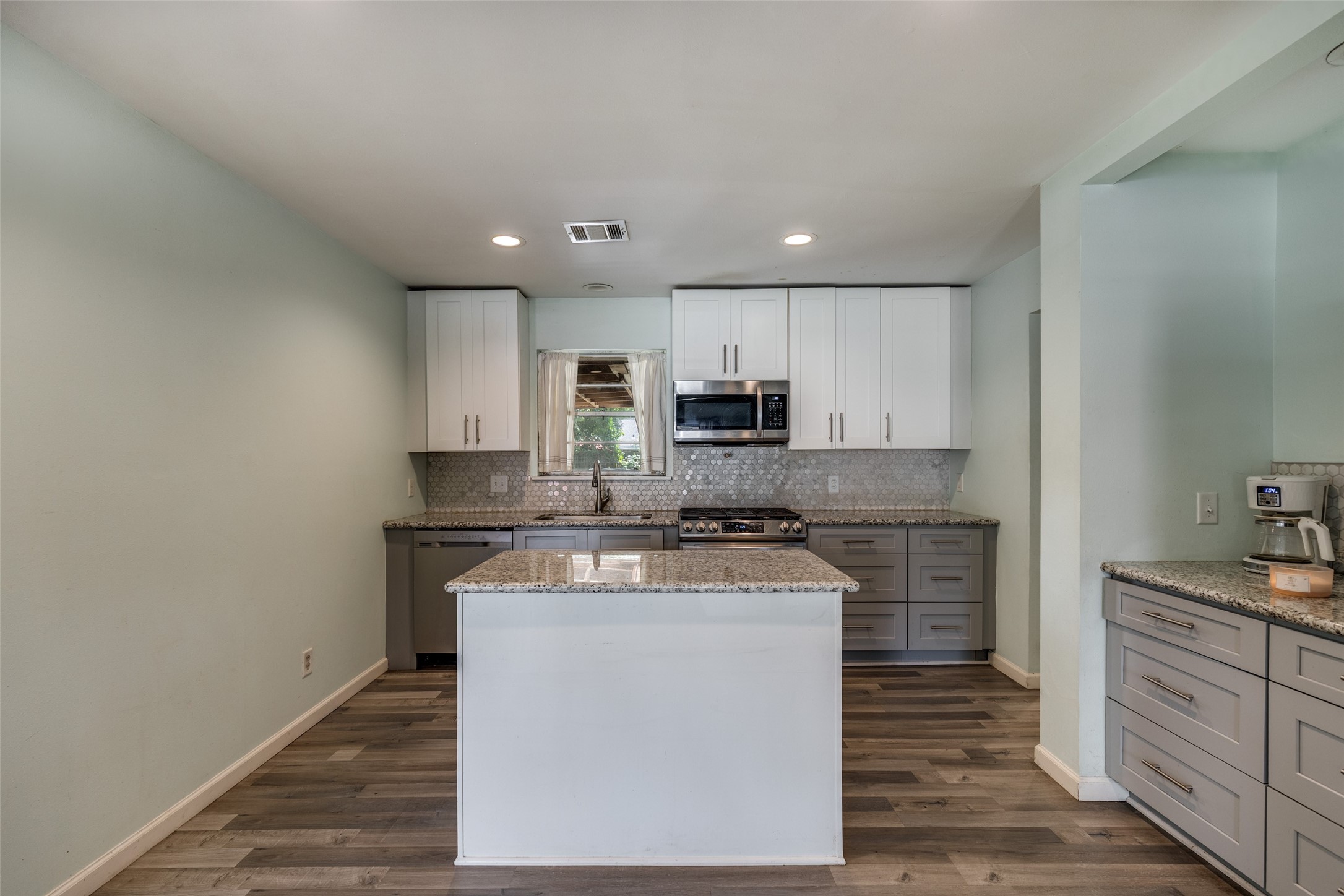 2007 Hewitt Drive Houston, TX 77018 - Photo 7 of 25 a kitchen with stainless steel appliances granite countertop a stove a sink and a refrigerator