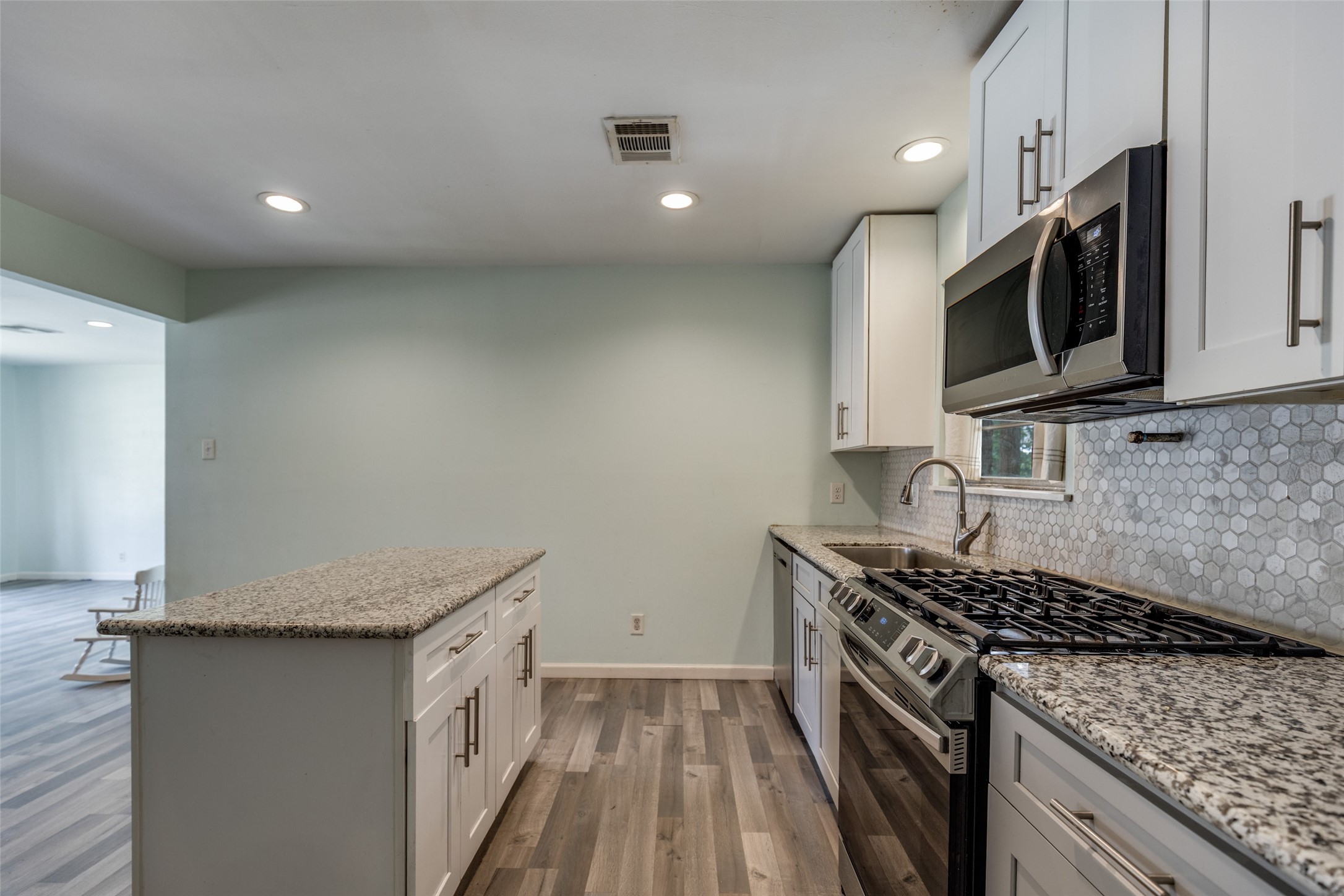 2007 Hewitt Drive Houston, TX 77018 - Photo 8 of 25 a kitchen with granite countertop a sink and steel appliances