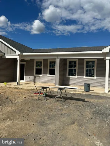 a swimming pool with outdoor seating and yard