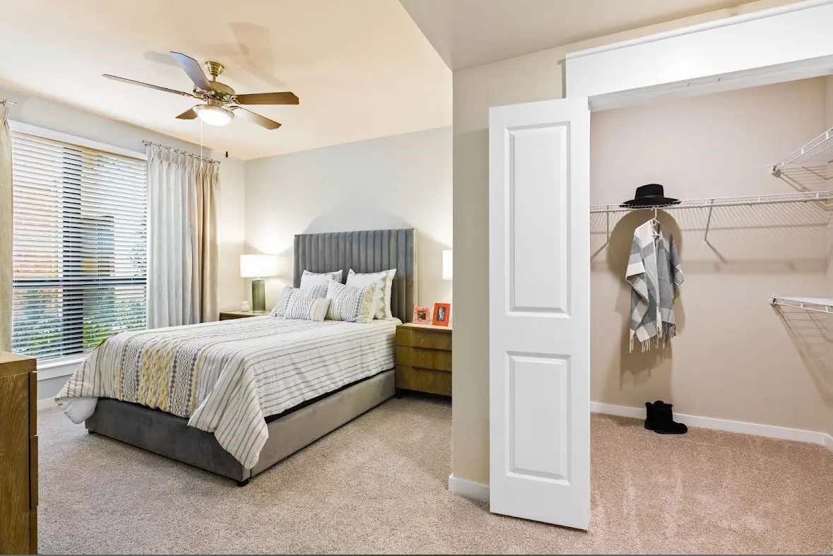 7204 Town Center Boulevard, Unit B4 Rosenberg, TX 77471 - Photo 8 of 17 a bedroom with a bed and a ceiling fan