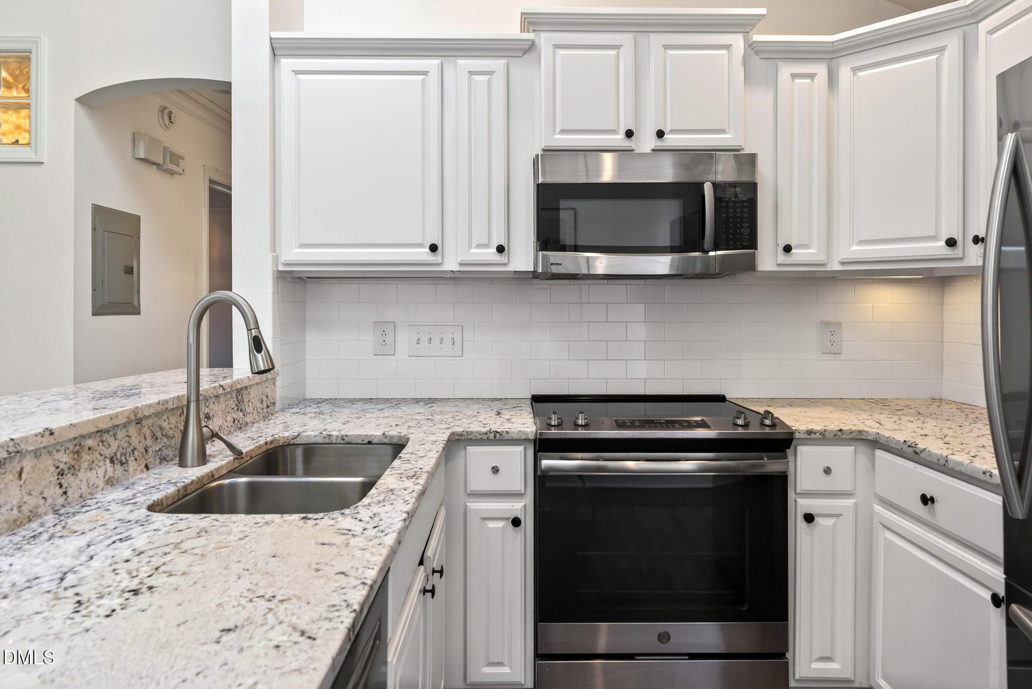 1901 Clark Avenue, Unit 105 Raleigh, NC 27605 - Photo 12 of 28 a kitchen with granite countertop white cabinets and stainless steel appliances