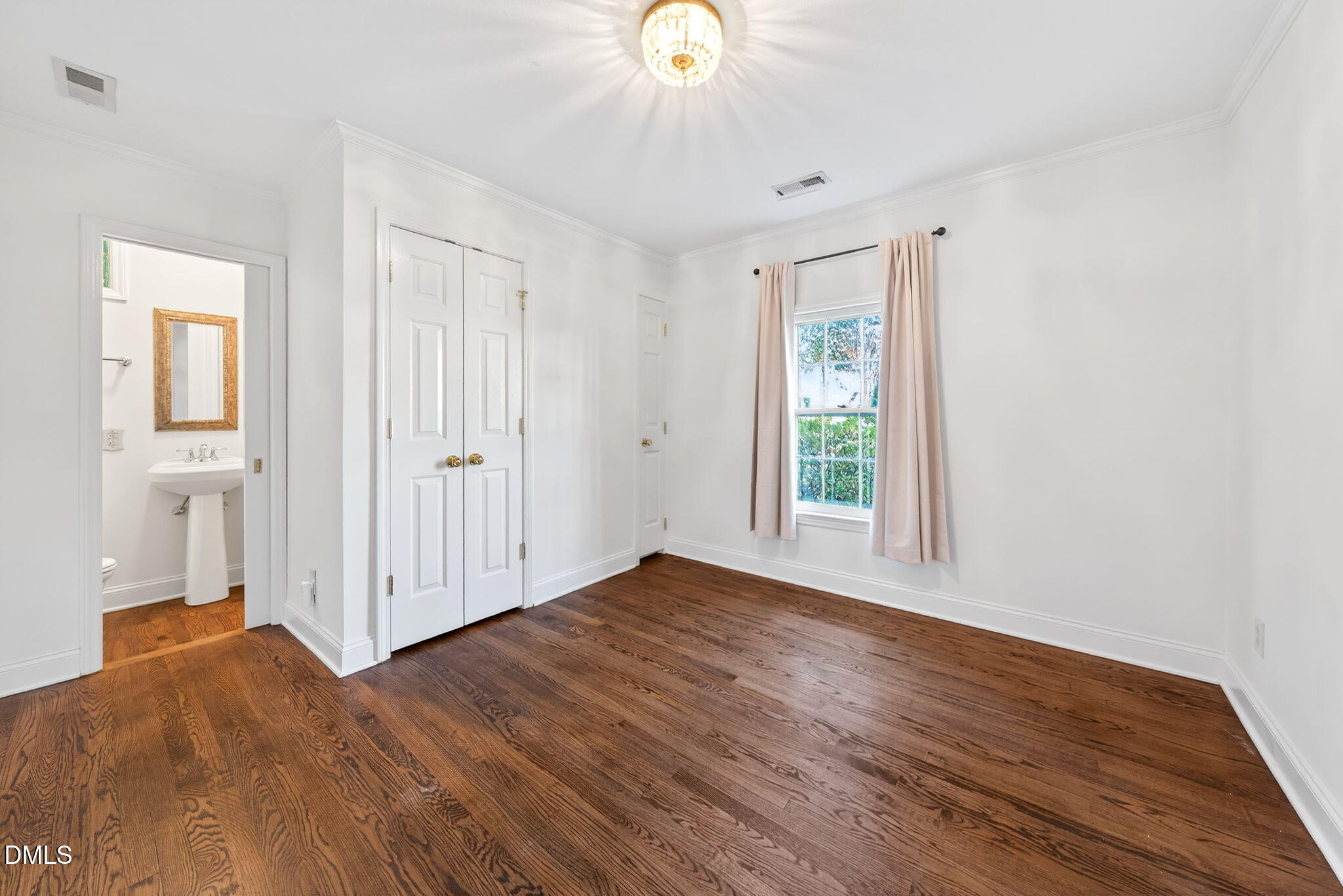 1901 Clark Avenue, Unit 105 Raleigh, NC 27605 - Photo 16 of 28 a view of an empty room with wooden floor and a window