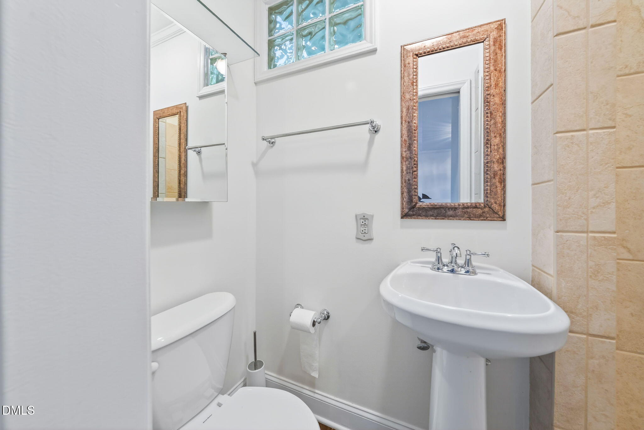 1901 Clark Avenue, Unit 105 Raleigh, NC 27605 - Photo 18 of 28 a bathroom with a toilet sink and mirror