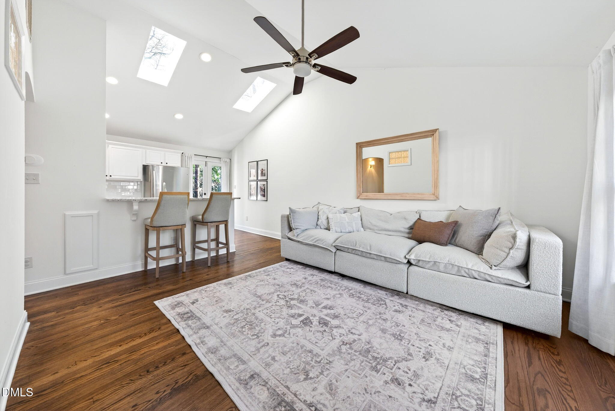 1901 Clark Avenue, Unit 105 Raleigh, NC 27605 - Photo 5 of 28 a living room with furniture and a wooden floor