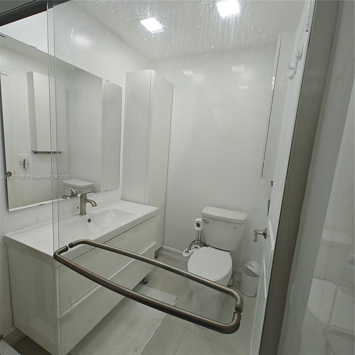 2750 Northeast 183rd Street, Unit 301 Aventura, FL 33160 - Photo 11 of 38 a bathroom with a sink and mirror