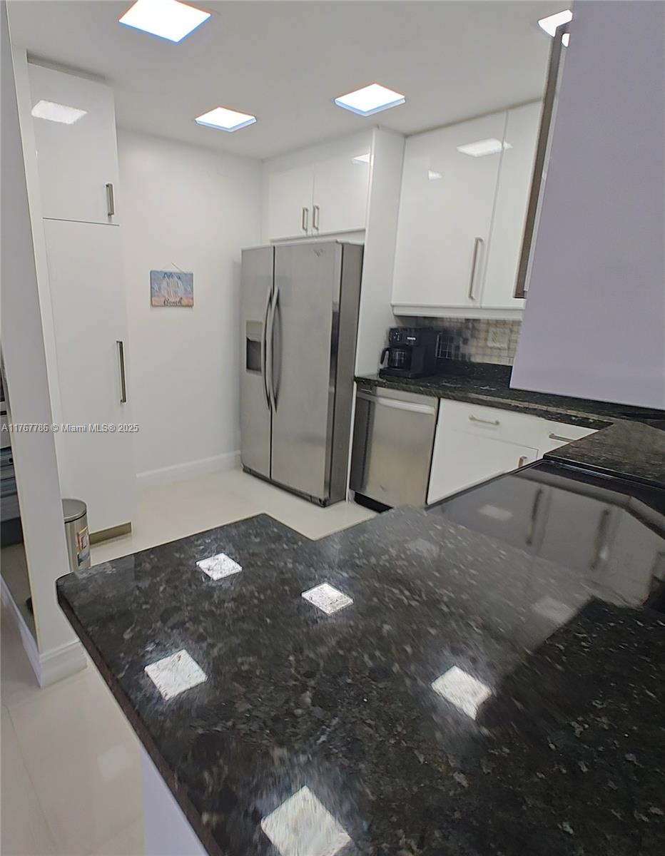 2750 Northeast 183rd Street, Unit 301 Aventura, FL 33160 - Photo 17 of 38 a view of a refrigerator in kitchen and wooden floor