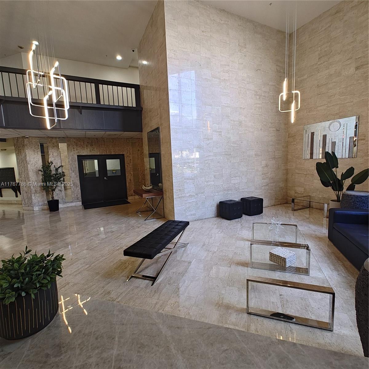 2750 Northeast 183rd Street, Unit 301 Aventura, FL 33160 - Photo 24 of 38 a living room with furniture and a fireplace