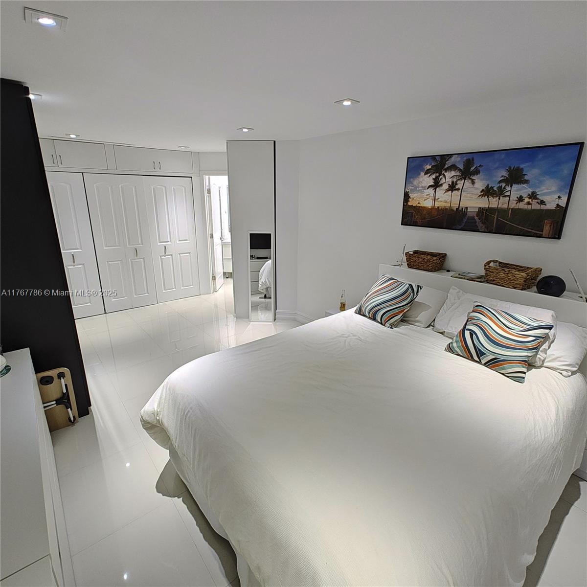 2750 Northeast 183rd Street, Unit 301 Aventura, FL 33160 - Photo 4 of 38 a bedroom with a bed and a flat screen tv