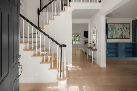 a view of entryway and hall with wooden floor