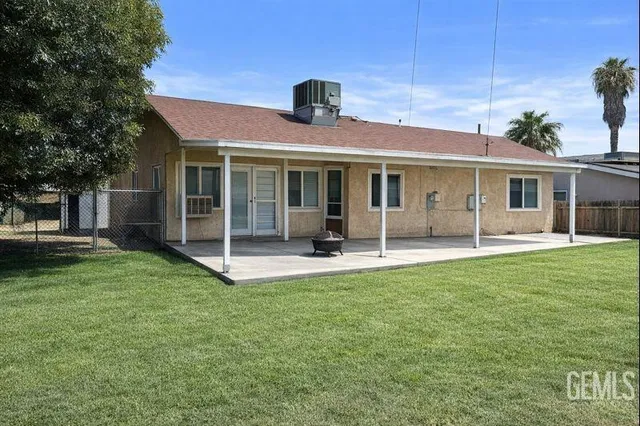 a view of a house with a backyard porch and sitting area