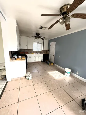 a kitchen with granite countertop a stove a sink and a refrigerator