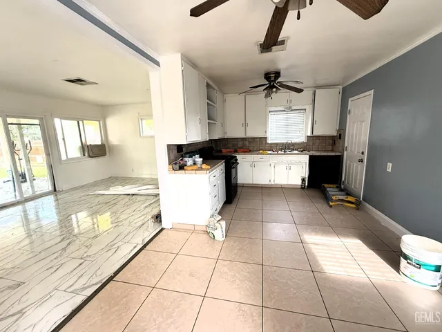 a kitchen with a stove a sink and cabinets