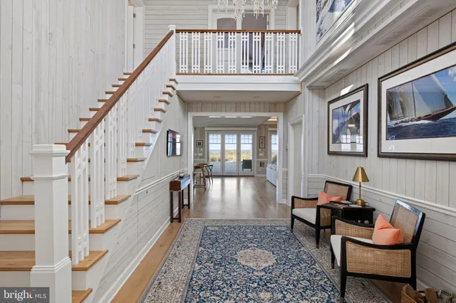 a bedroom with a large bed and wooden floor