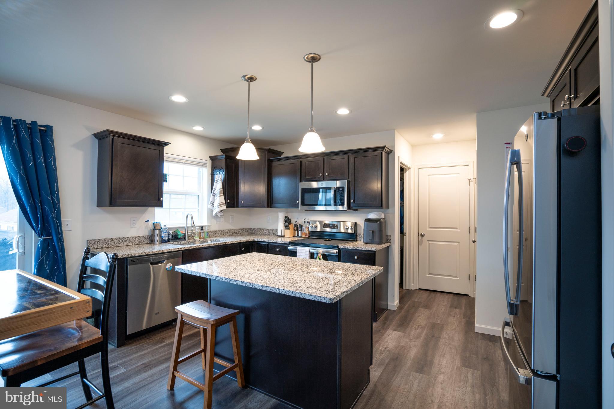 273 Fawn Valley Road State College, PA 16803 - Photo 11 of 47 a kitchen with a sink a center island stainless steel appliances and cabinets
