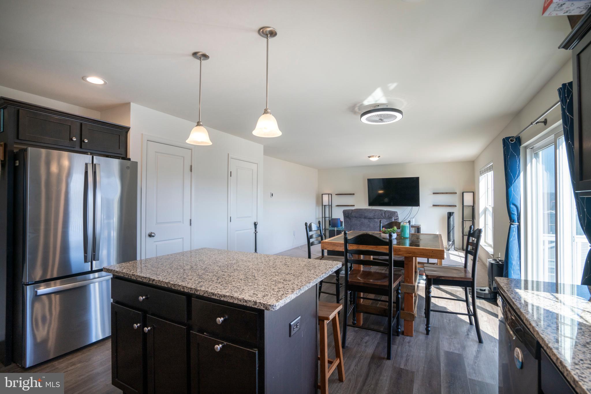 273 Fawn Valley Road State College, PA 16803 - Photo 14 of 47 a kitchen with kitchen island a refrigerator a stove a microwave oven a sink with island and chairs