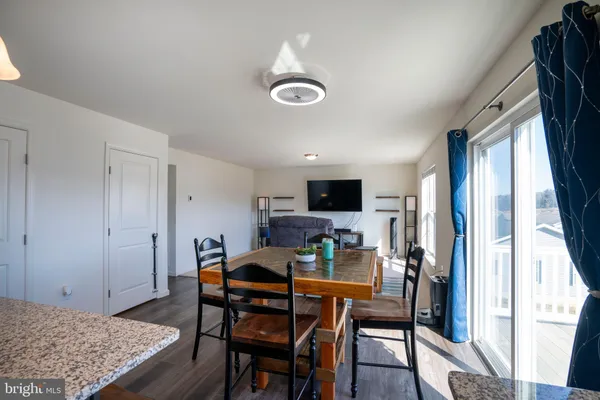 a view of a dining room with furniture and a window
