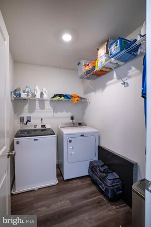a kitchen with a sink stove and wooden floor